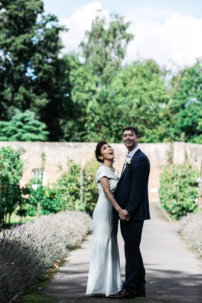 garden shot of happy bride and groom wedding photography for kent wedding at brabourne house 